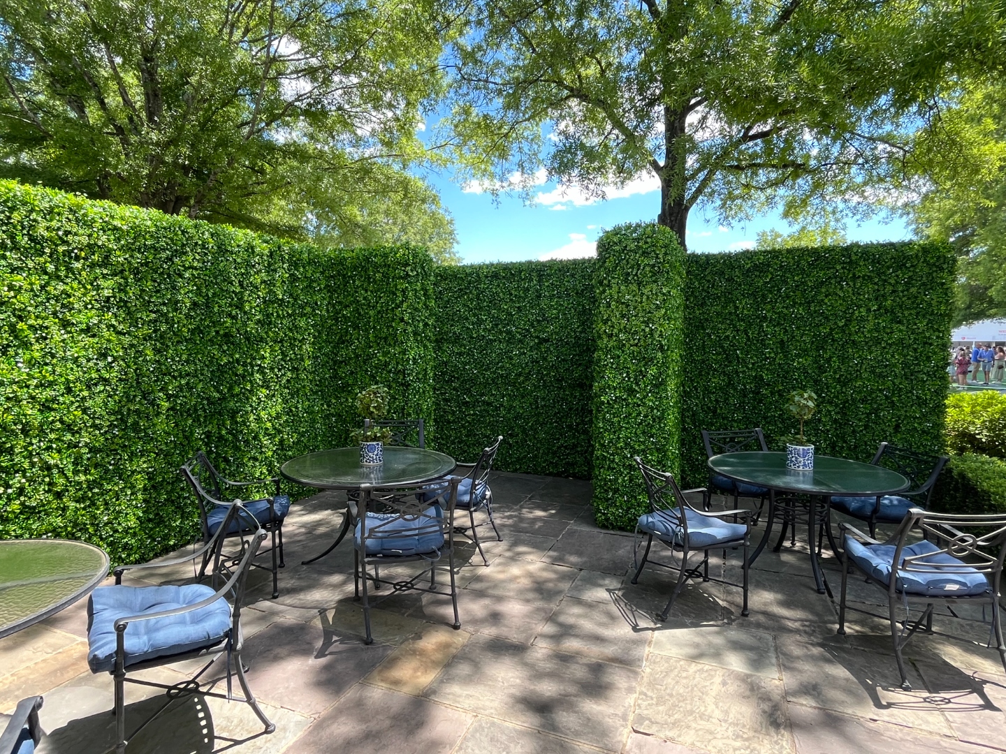 Faux Jasmine hedge walls framing a private outdoor lounge seating area